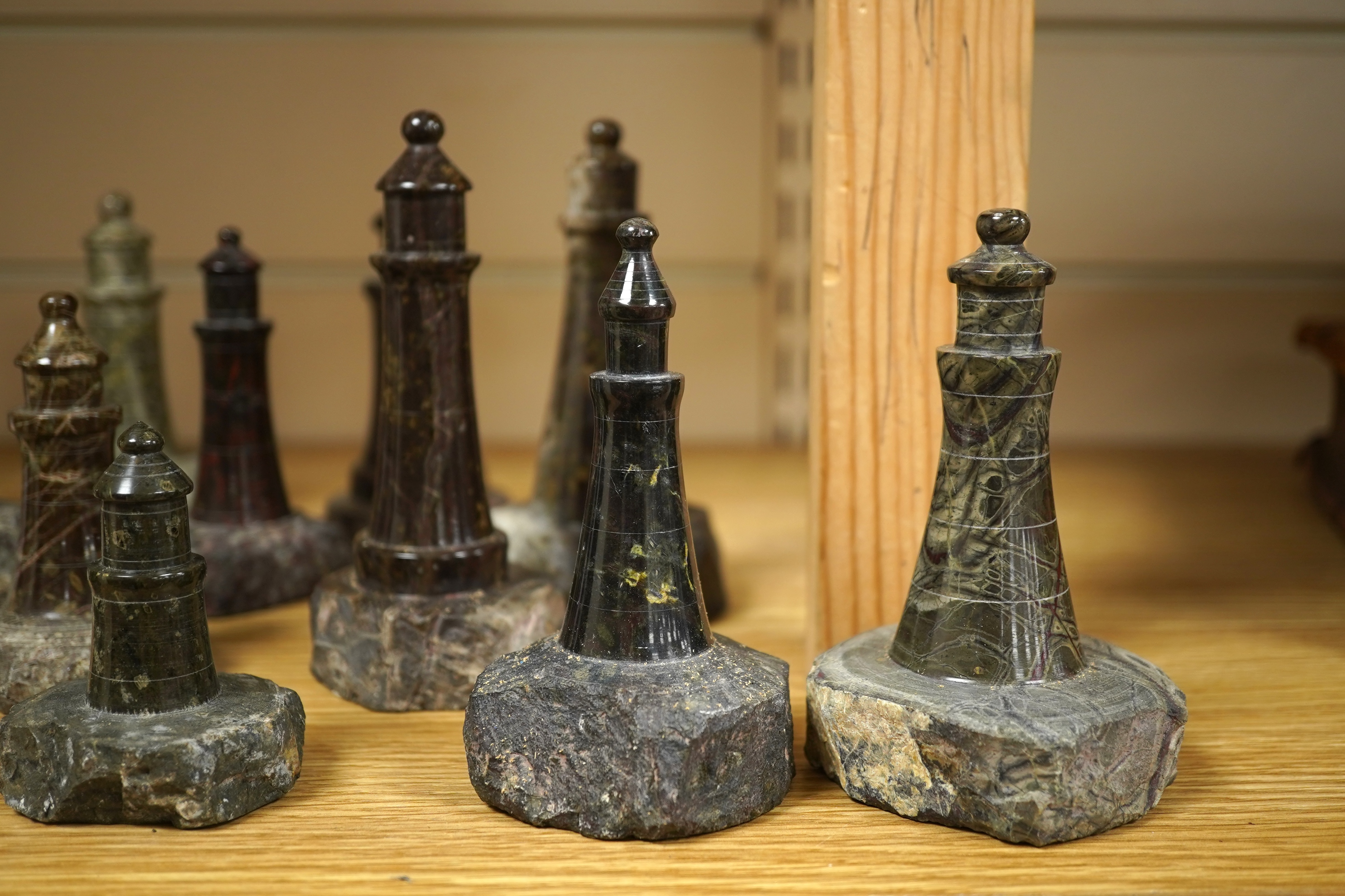 A collection of Cornish serpentine stone carved lighthouses, tallest 13cm high